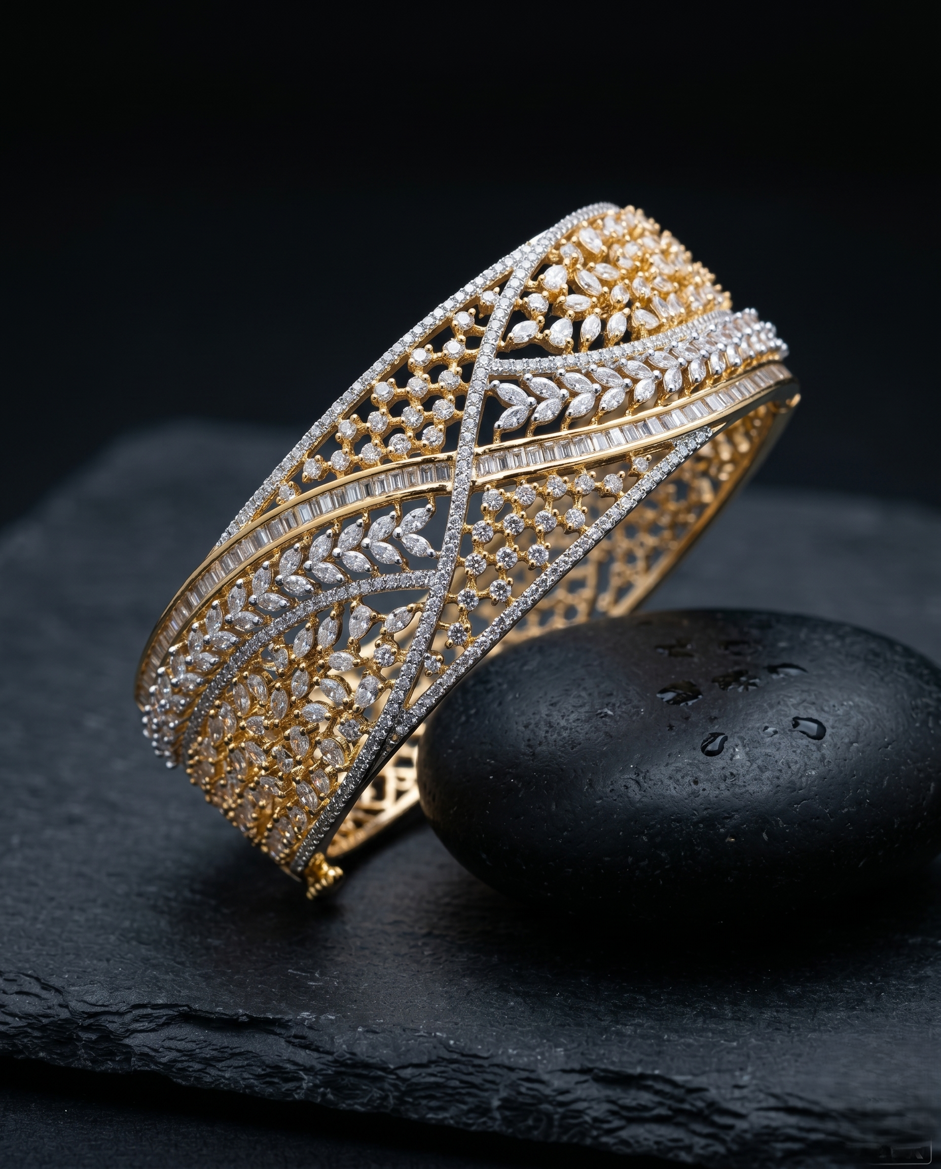 Gold and silver bracelet on a dark stone surface with a black background