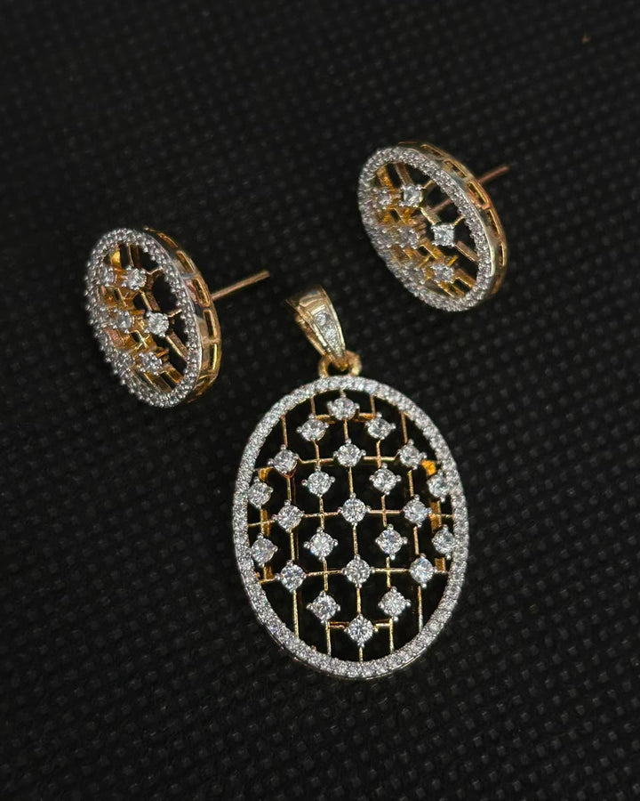 Gold and white stone jewelry set featuring a large oval pendant and matching stud earrings, displayed on a textured black background.