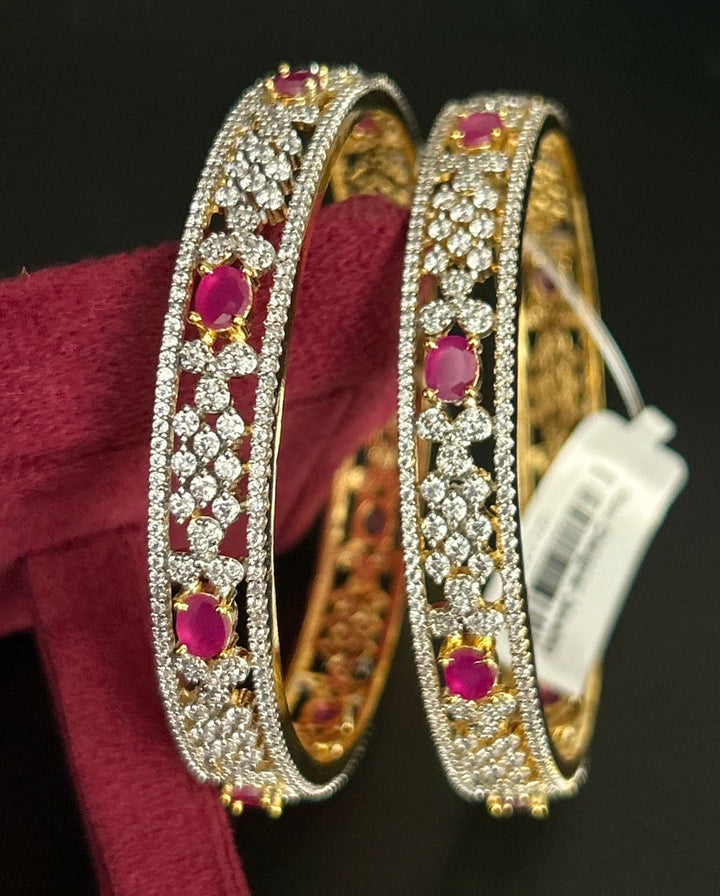 Gold-finish bangle pair accented with ruby stones and diamond-inspired detailing