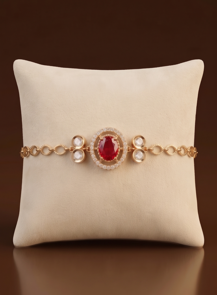 Gold bracelet with a red gemstone on a beige pillow against a brown background