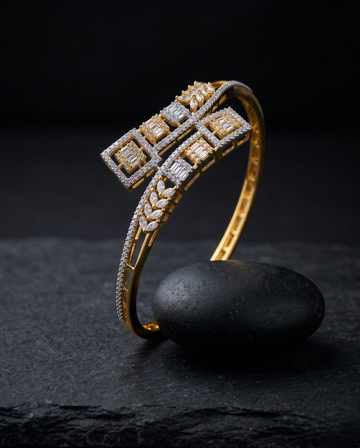Gold bracelet with diamond accents on a dark surface