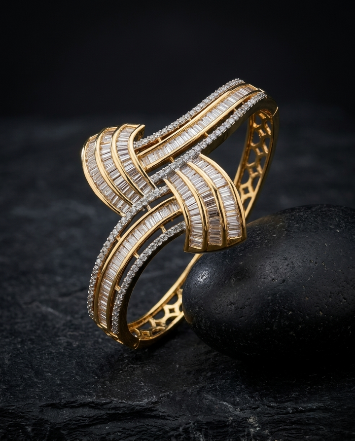 Gold bracelet with diamond accents on a dark textured surface