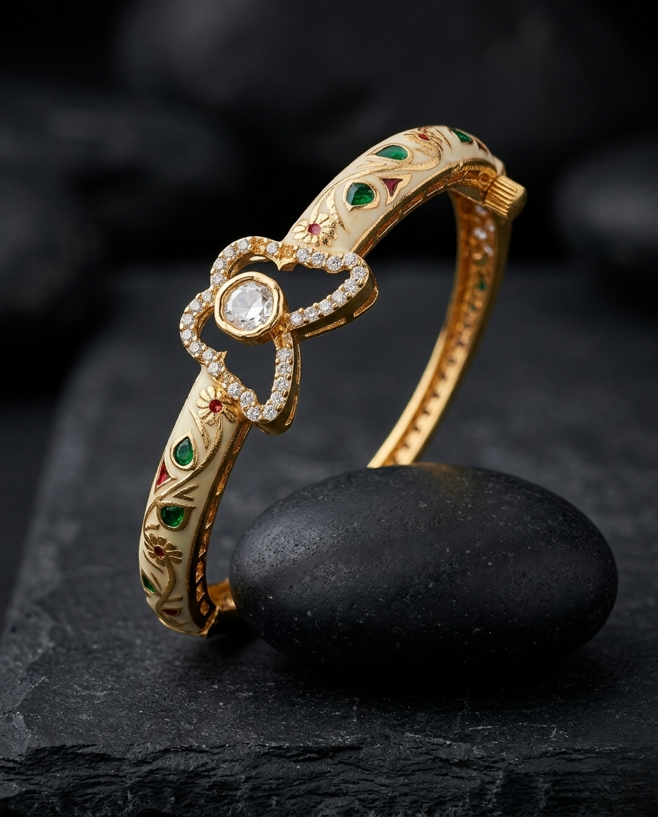 Gold bracelet with gemstones on a dark stone surface