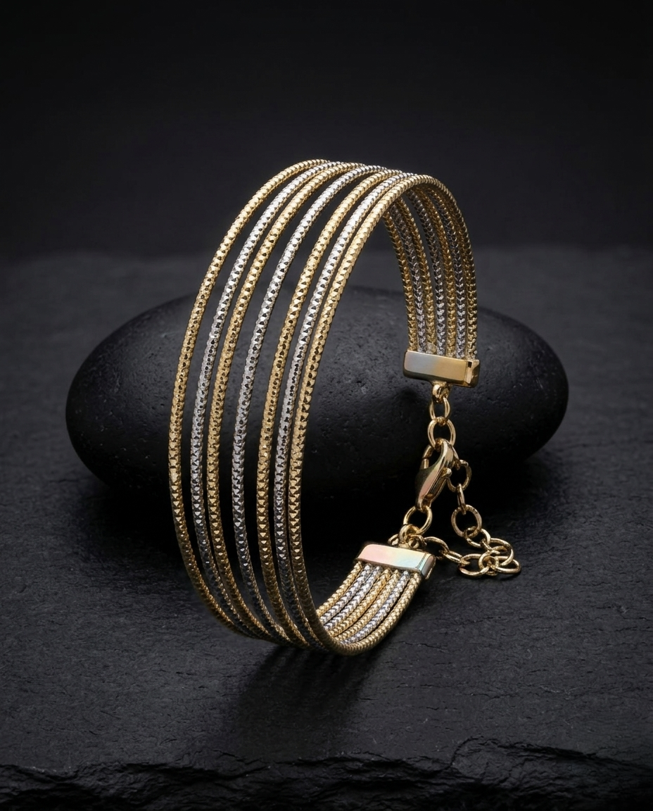Gold bracelet with multiple chains on a dark stone surface