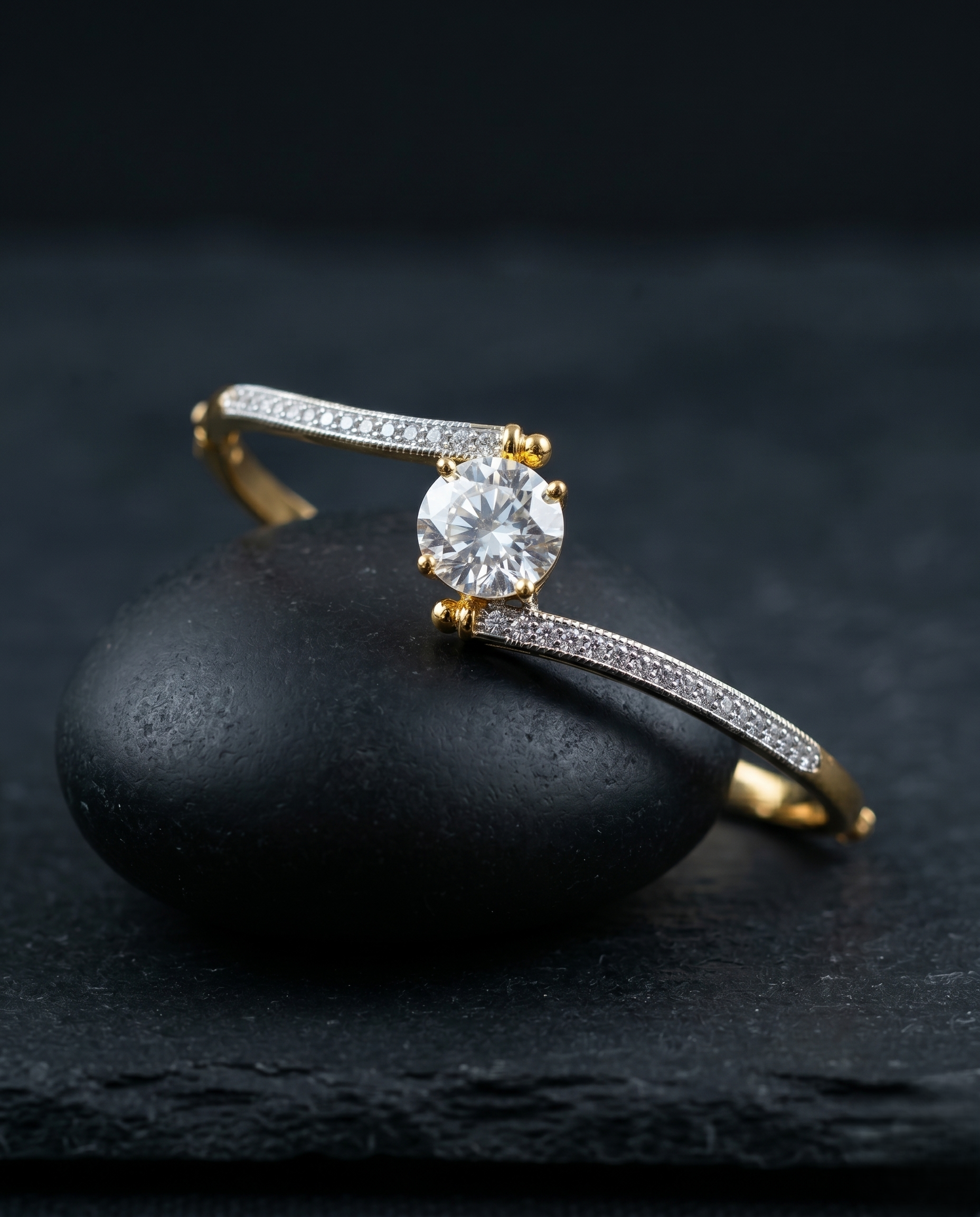 Gold diamond bracelet on a dark stone surface