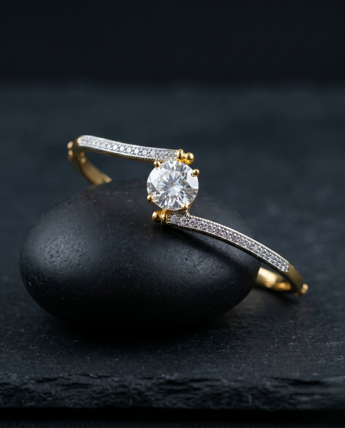 Gold diamond bracelet on a dark stone surface