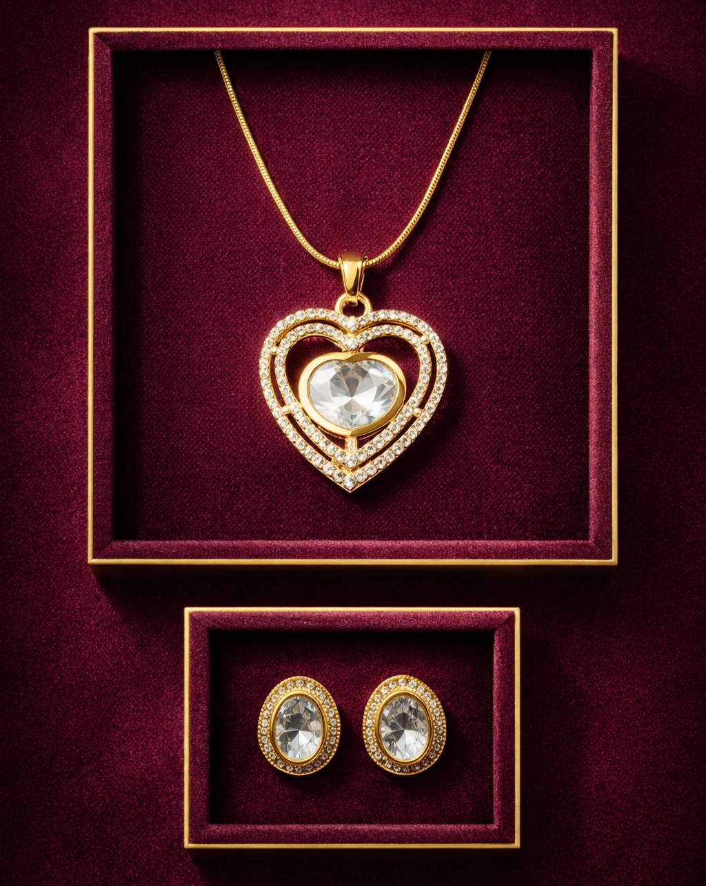 Gold heart-shaped pendant and matching earrings on a burgundy background