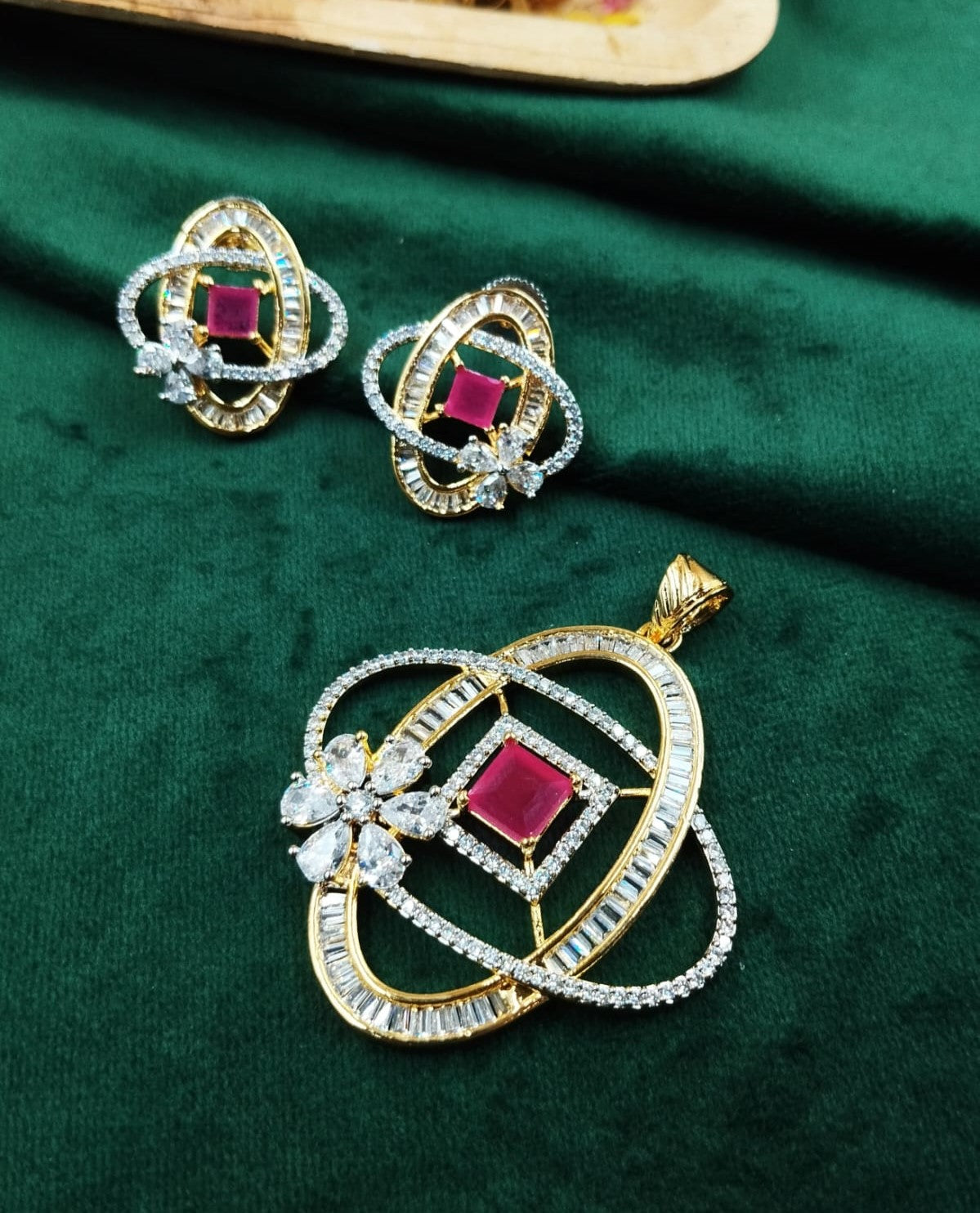 Designer gold toned pendant set featuring pink ruby square stones, modern statement jewellery for sale