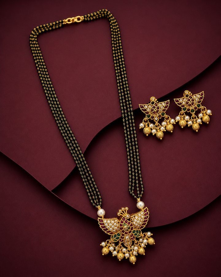 Gold necklace and earrings on a maroon background