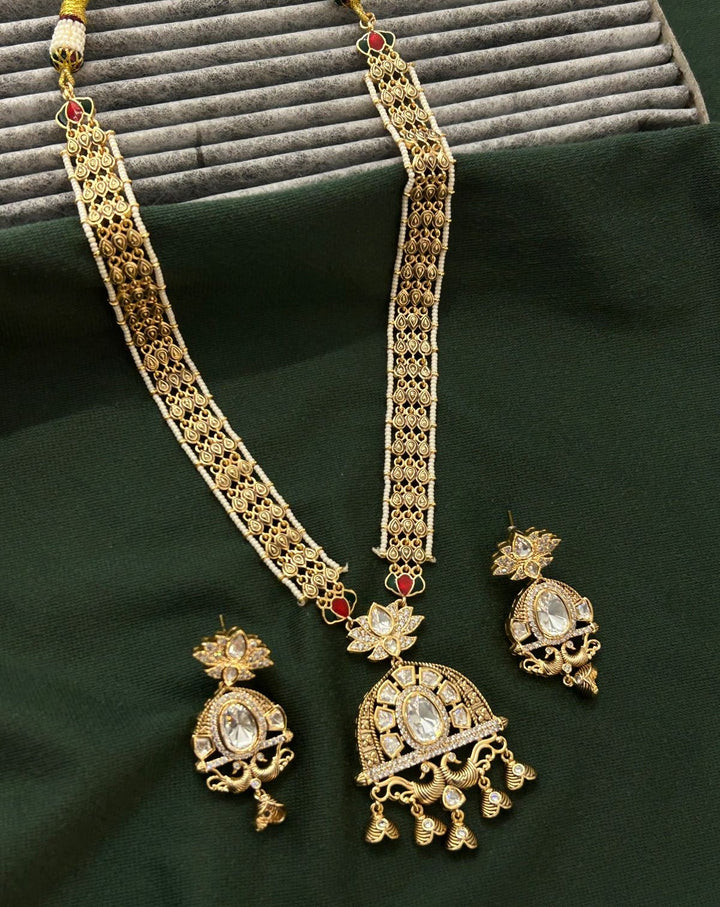 Elegant kundan necklace and earring set finished in classic antique gold tone