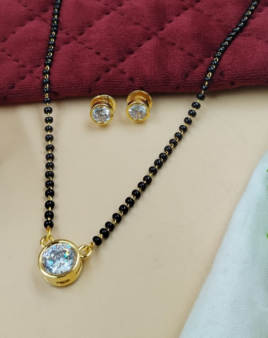 Gold finish solitaire mangalsutra with black bead chain and matching stud earrings, minimal everyday wear design