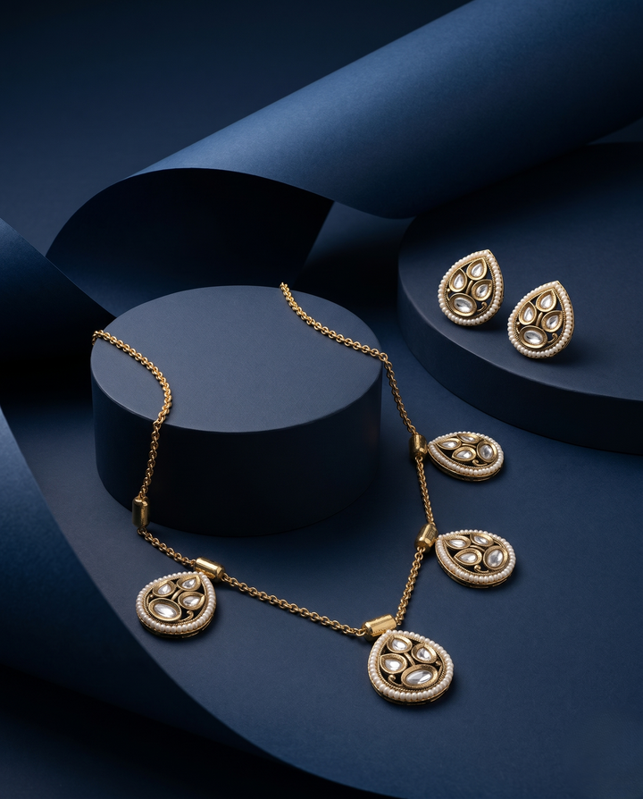 Gold necklace earrings a dark blue background