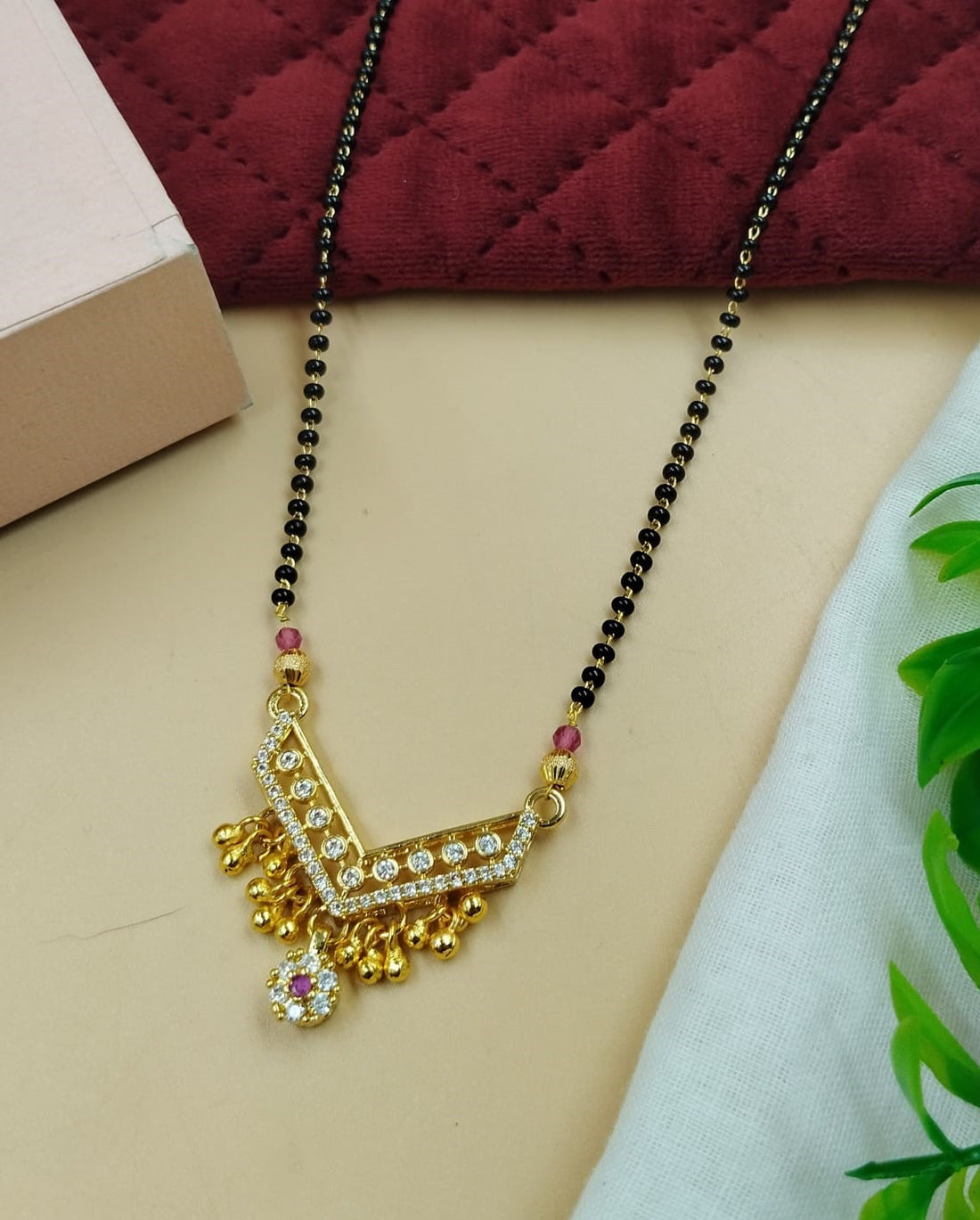 Elegant women’s mangalsutra designed with V motif pendant and sparkling stone accents