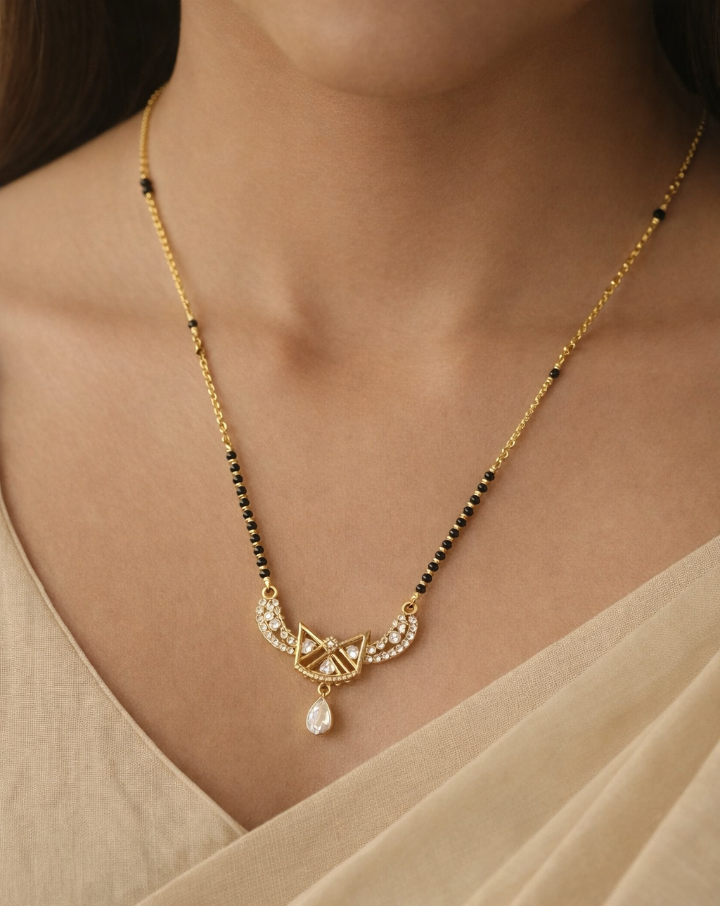 Gold-finish mangalsutra necklace featuring a geometric triangle diamond-style pendant