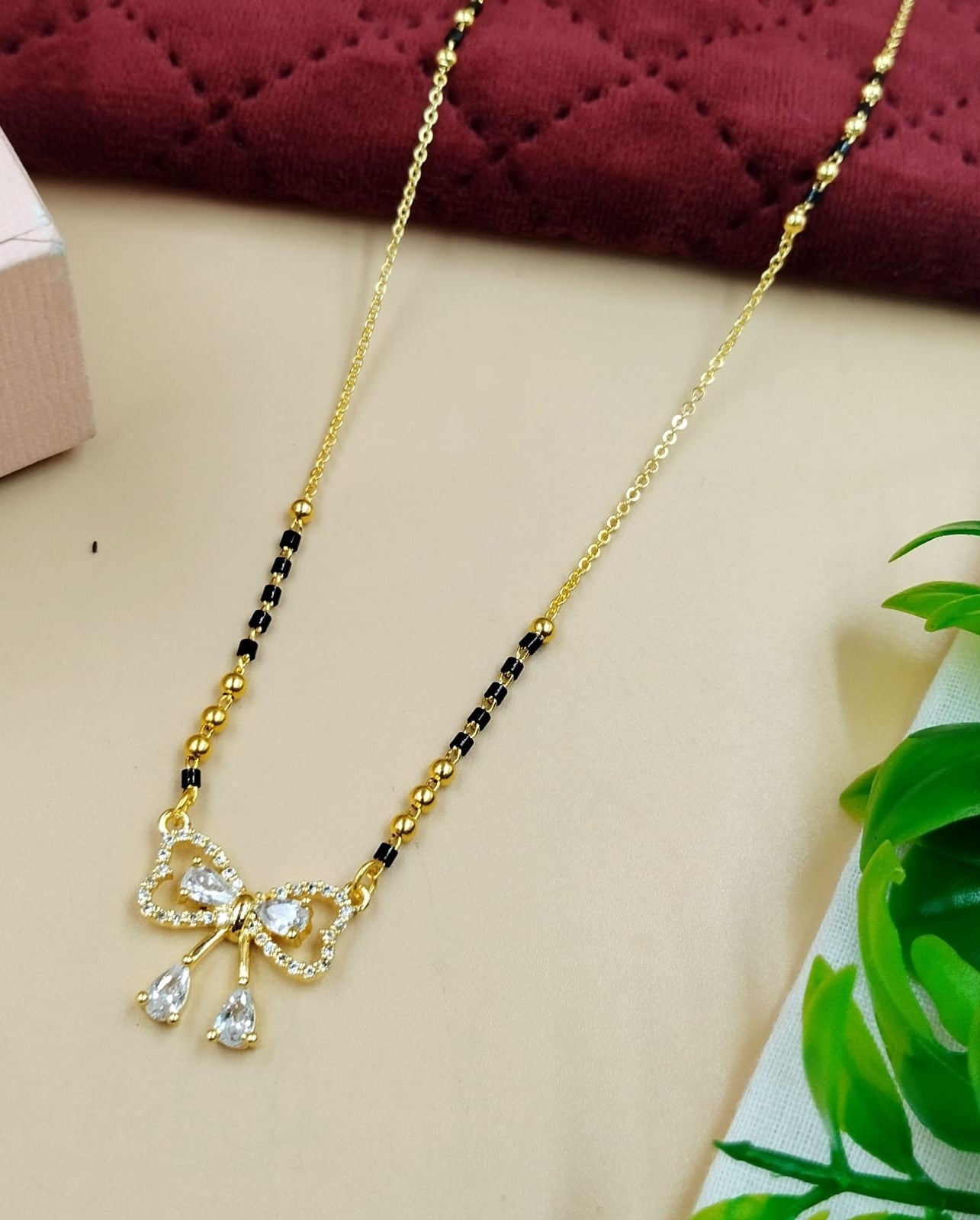 Elegant women’s mangalsutra designed with a delicate bow motif and subtle sparkle