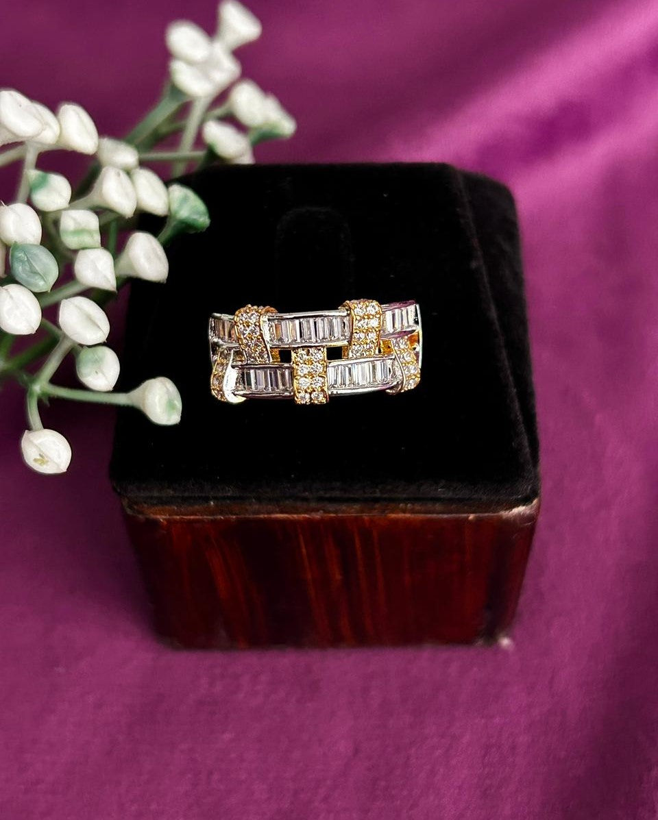 Gold ring with diamonds on a black box against a purple background