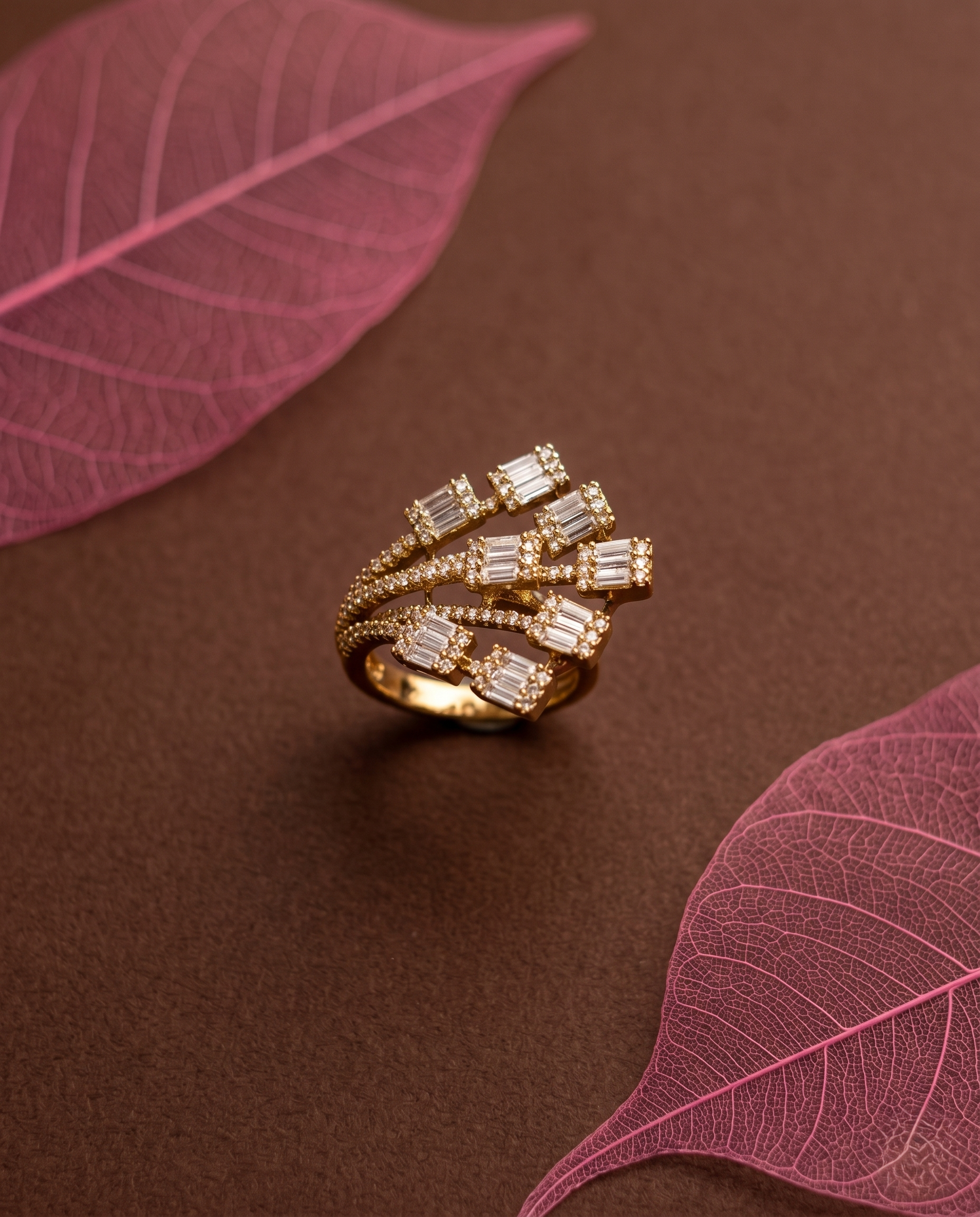 Gold ring with diamonds on surface with pink leaves