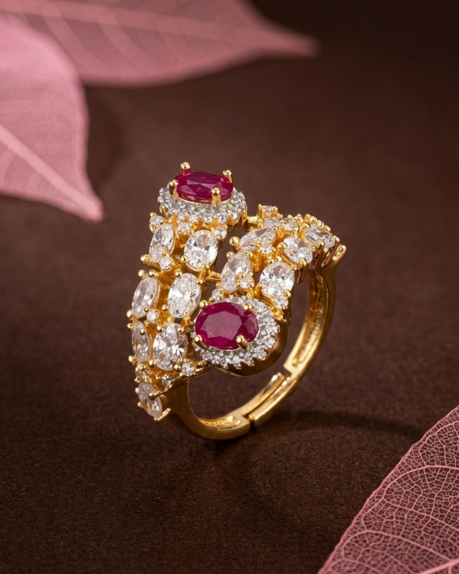 Gold ring with red gemstones and diamonds on a brown background