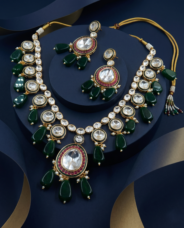 Green Kundan Bead Drop Necklace Set with Earrings with blue background 
