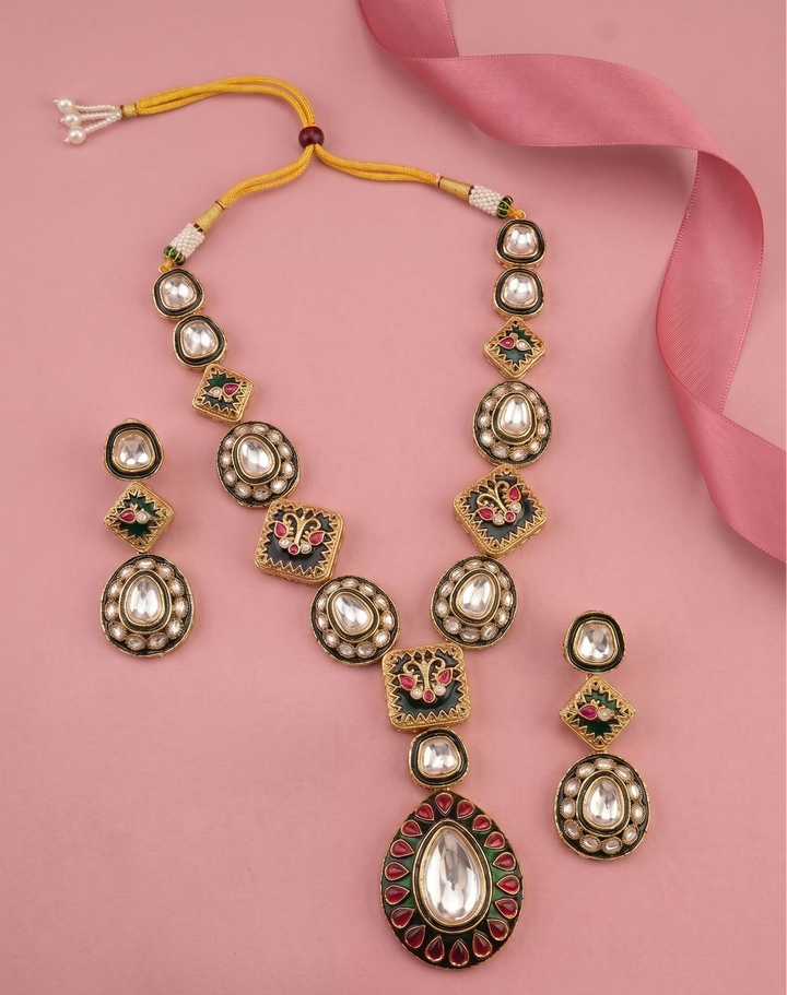 Green Meena Kundan Necklace Set with Earrings with pink background 
