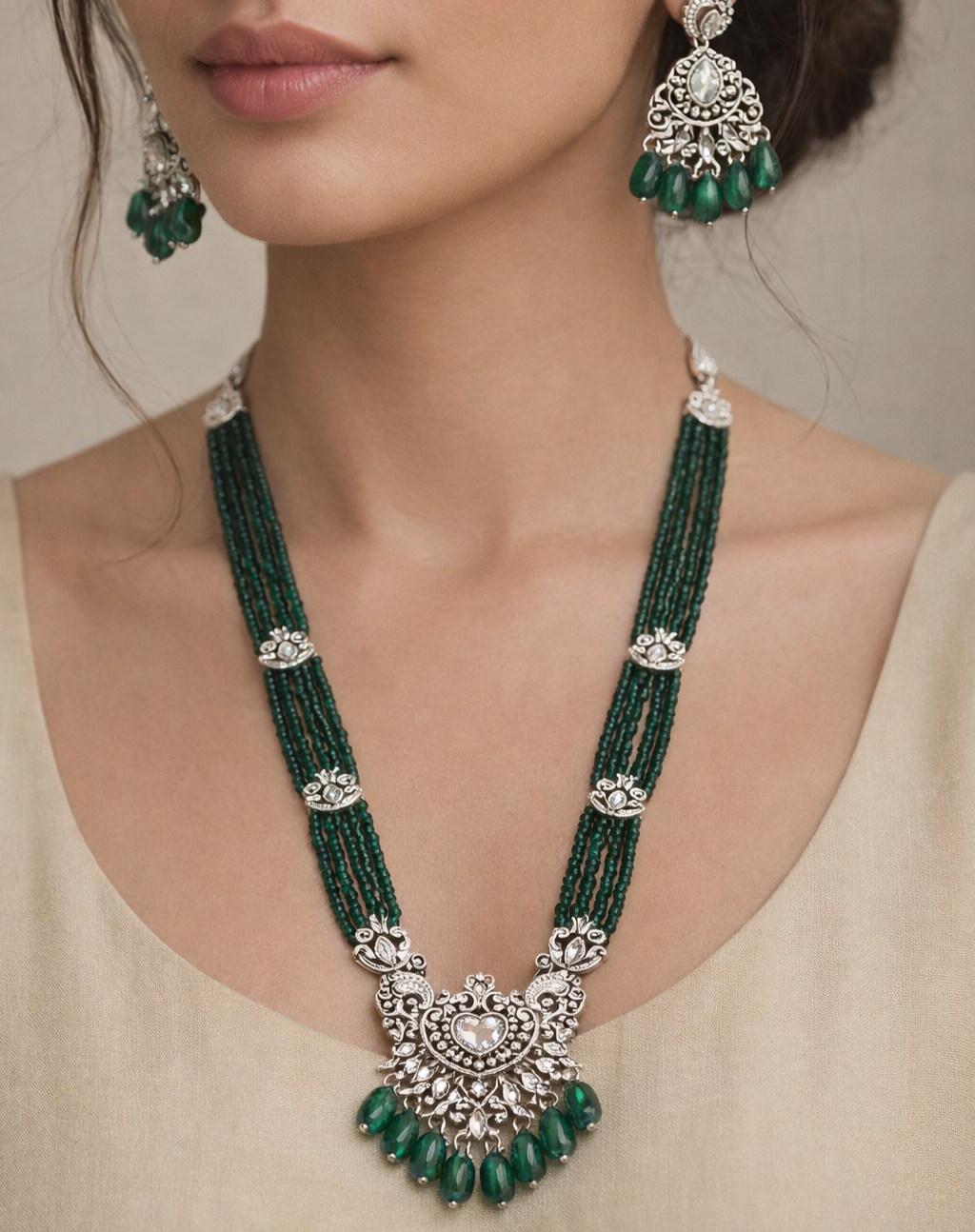 Green beaded necklace with silver accents worn 