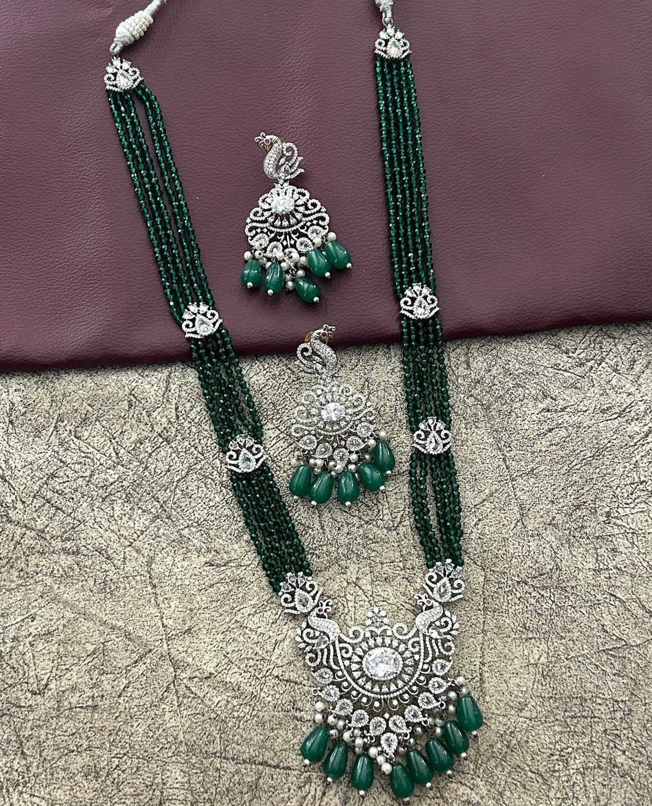 Green beaded necklace with silver pendant and matching earrings 