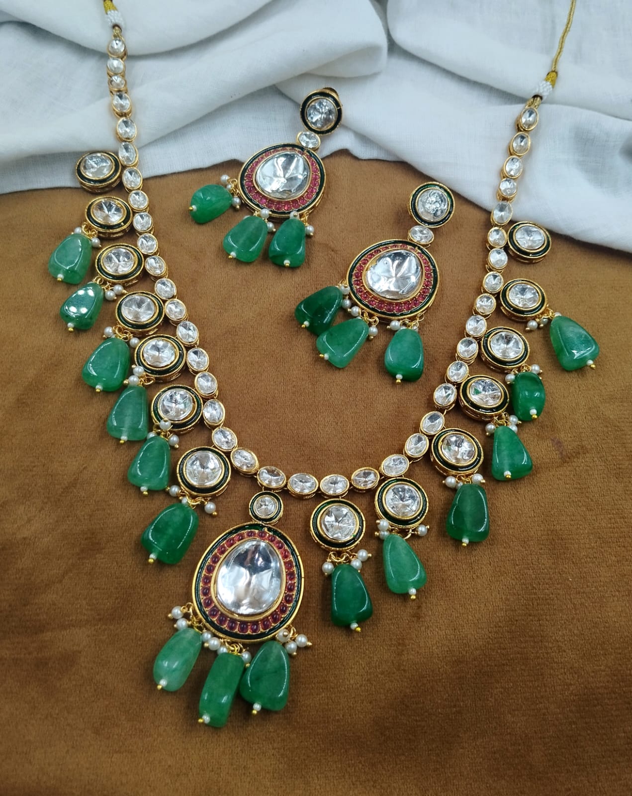 Traditional green kundan necklace featuring bead drop detailing with matching earrings