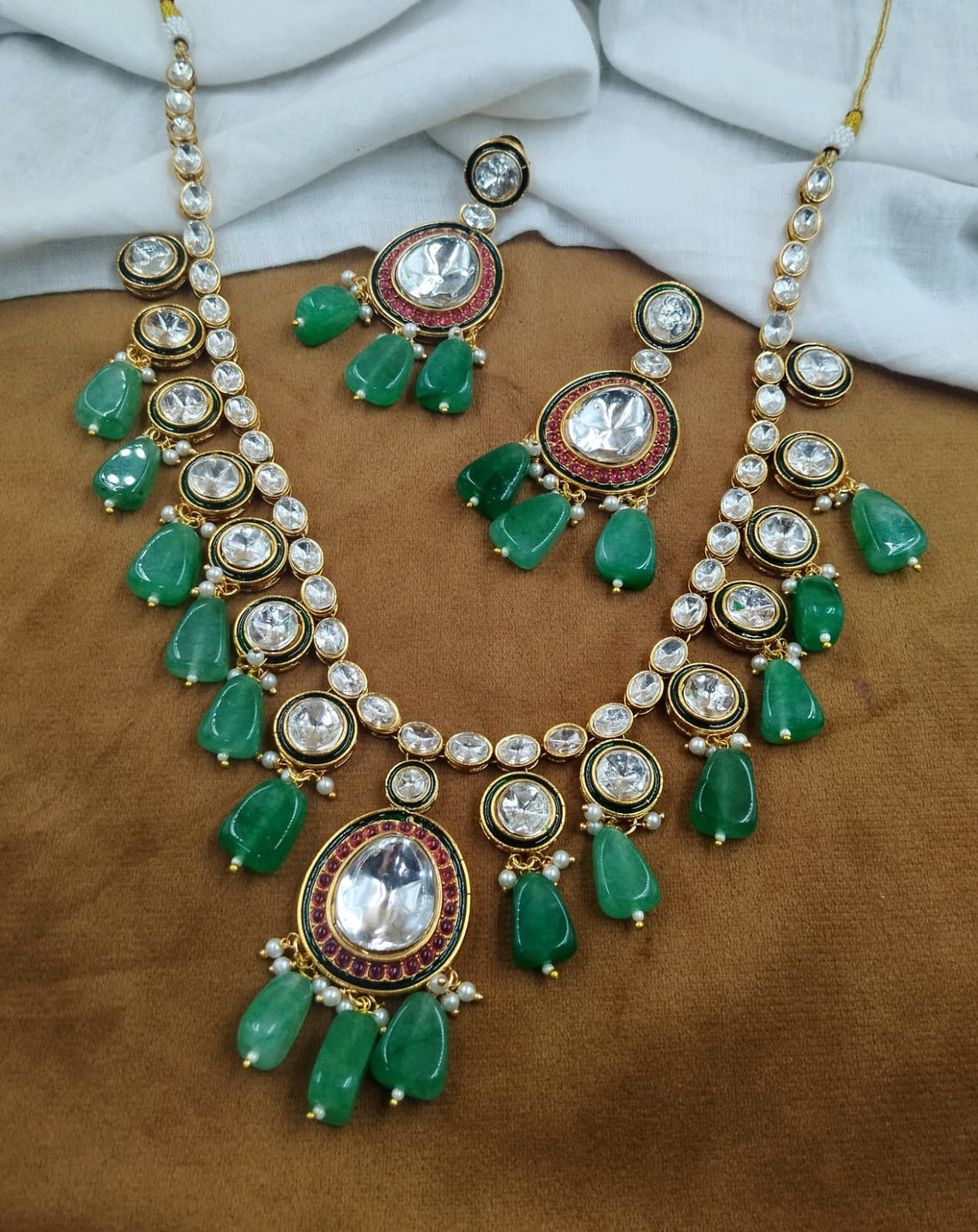 Traditional green kundan necklace featuring bead drop detailing with matching earrings