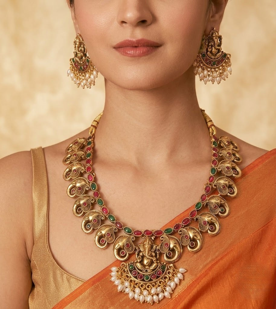 he matching Ganesha earrings complete this regal ensemble, making it an ideal accessory for brides, festive celebrations, religious ceremonies, and cultural events