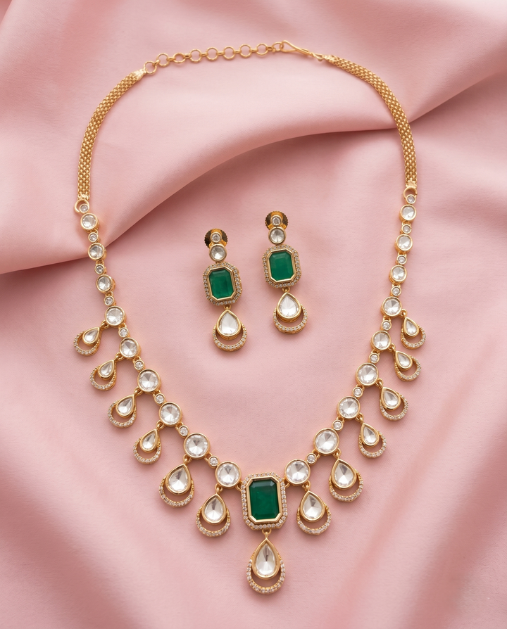 Jewelry set with necklace and earrings on a pink fabric background