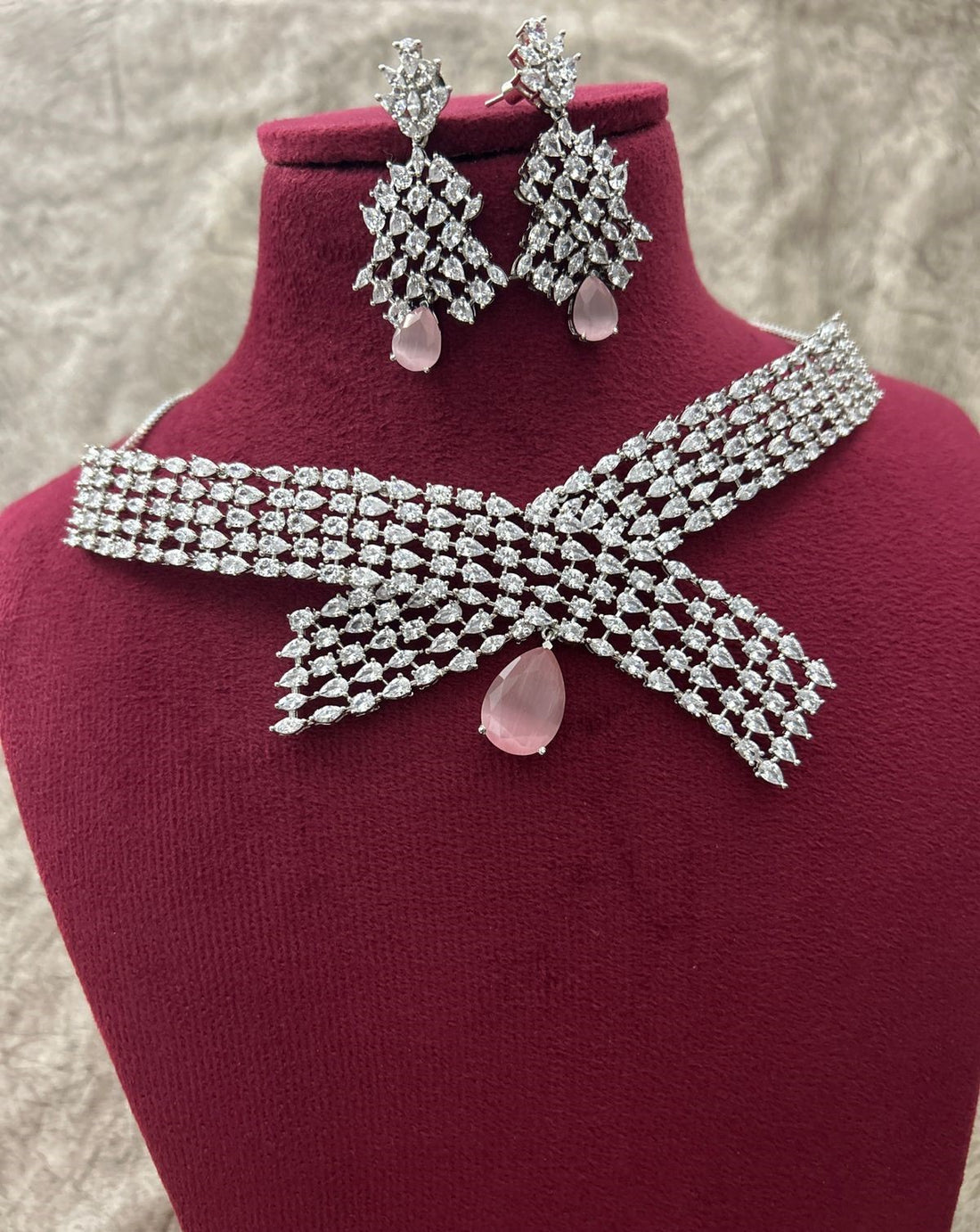 Jewelry set with necklace and earrings on a mannequin bust.