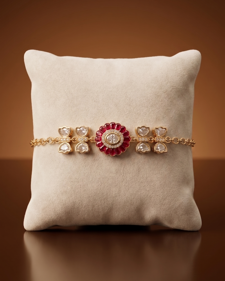 Jewelry set with a pink and gold bracelet on a beige cushion against a brown background