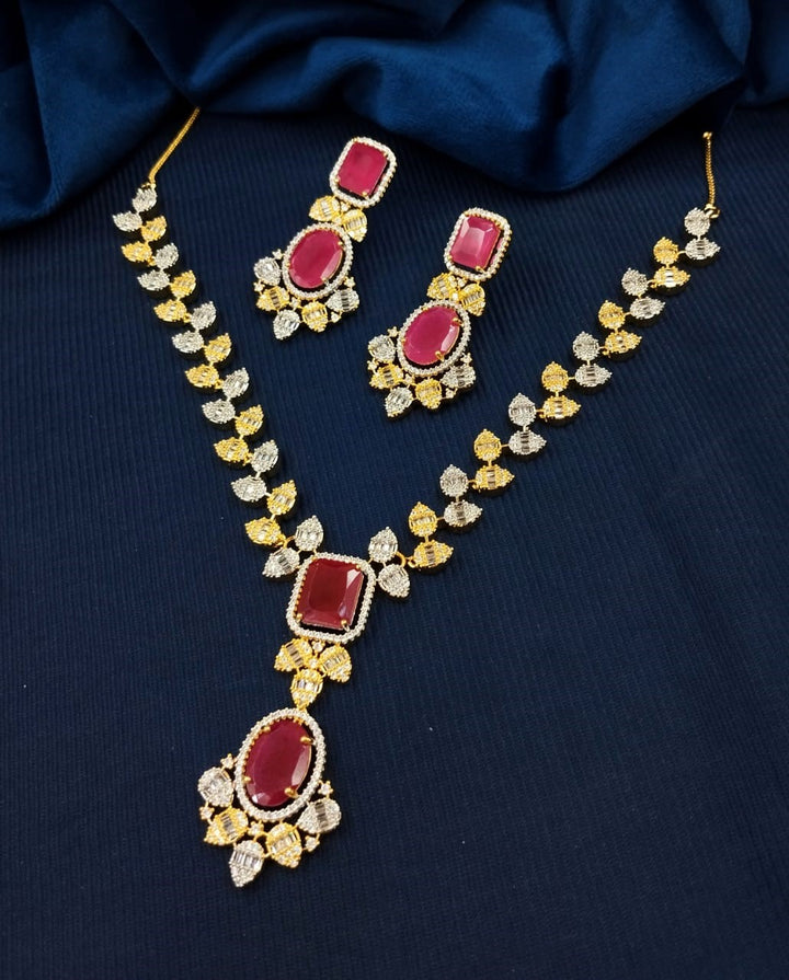 Jewelry set with necklace and earrings on a dark blue fabric background