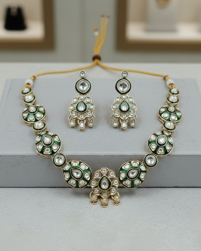 Green kundan necklace set paired with matching earrings and maang tikka