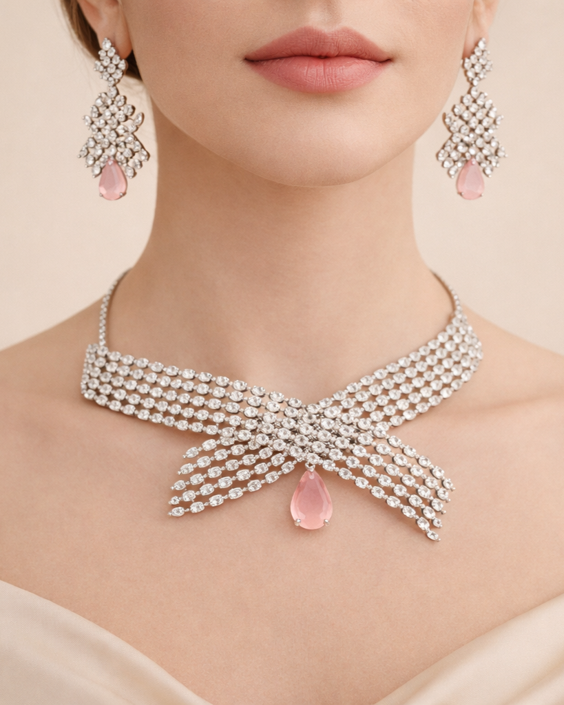 Jewelry set with necklace and earrings featuring pink stones on a neutral background