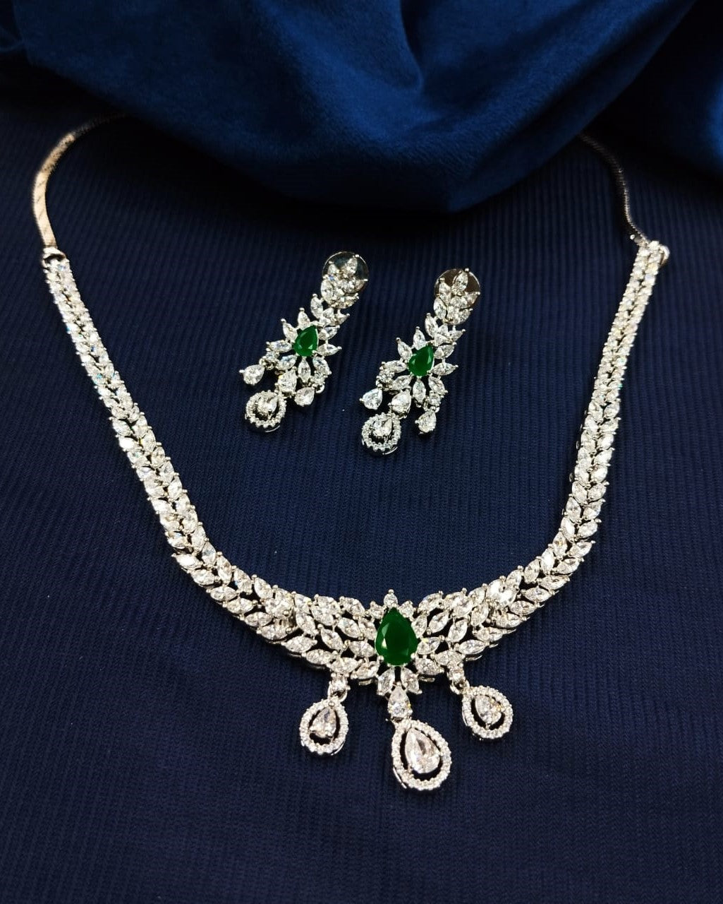 Silver finish diamond style necklace set featuring green stone detailing with earrings