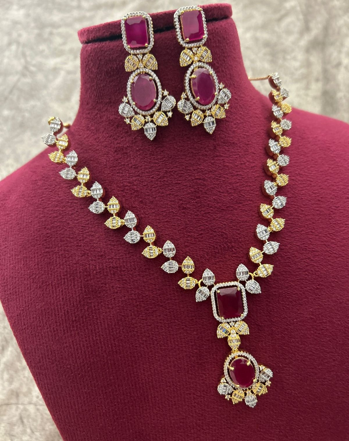 Jewelry set with necklace and earrings on a mannequin bust.
