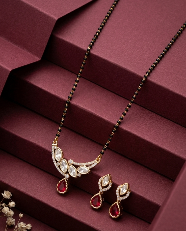 Jewelry set with necklace and earrings on a maroon surface
