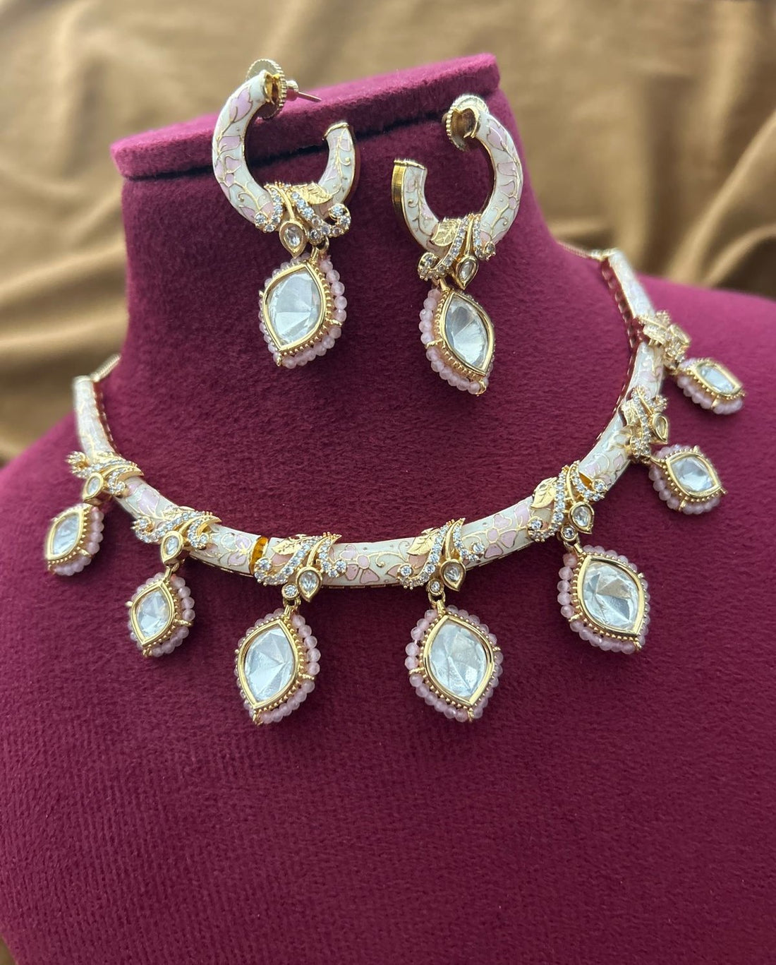 Antique gold–tone kundan jewellery featuring soft pink enamel detailing for weddings