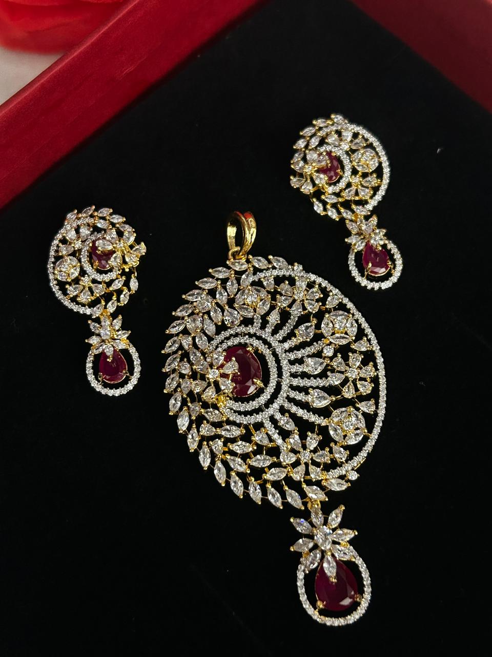 Jewelry set with pendant and earrings on a black background