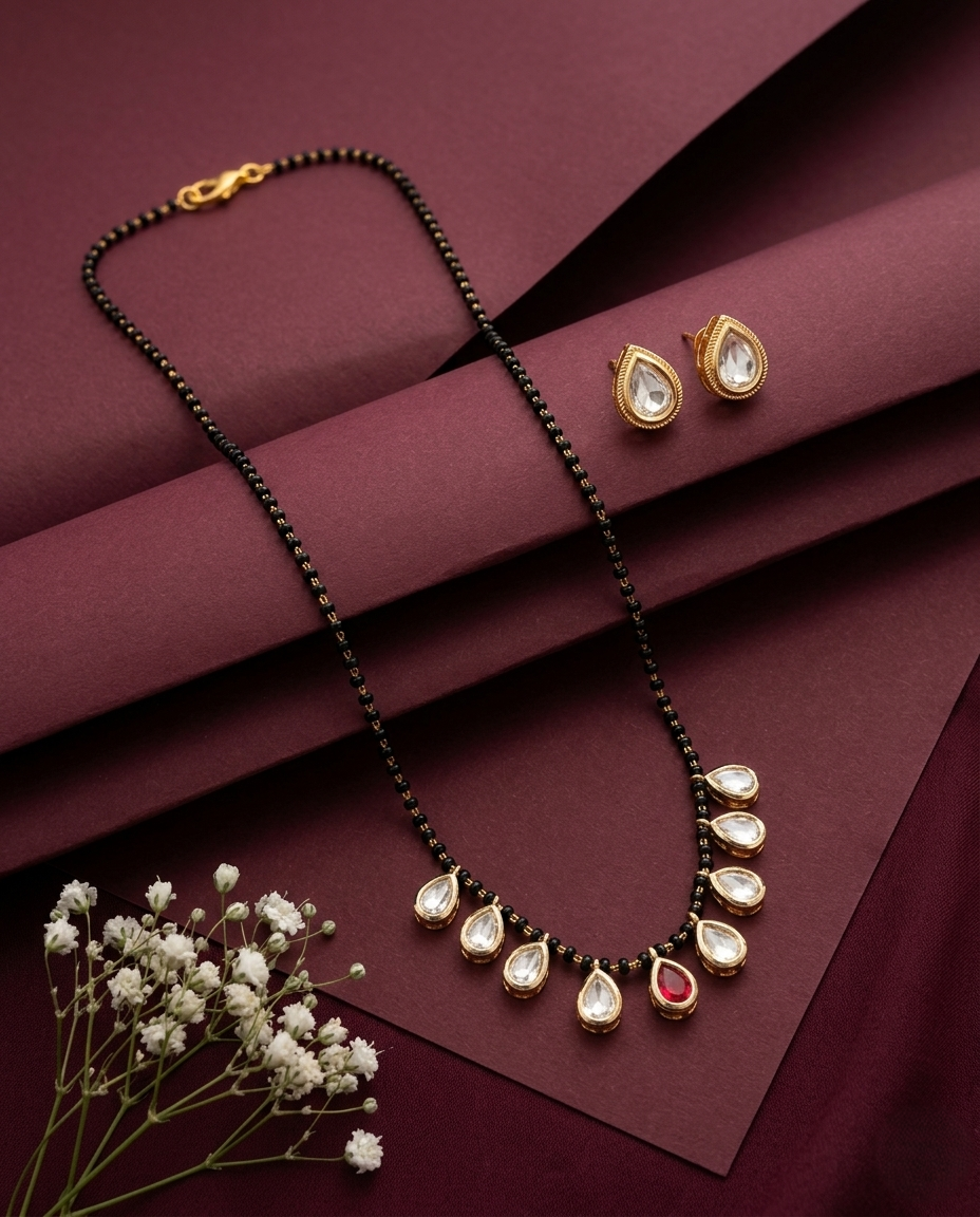 Jewelry set with necklace and earrings on a maroon background