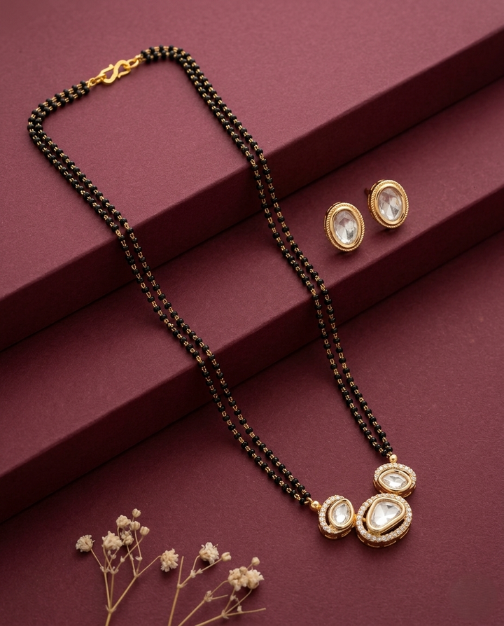 Jewelry set with necklace and earrings on a maroon surface