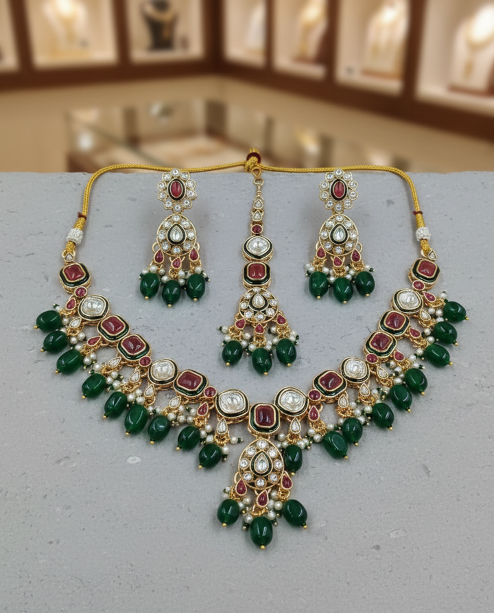 Polki kundan necklace set with ruby tone stones and green bead drops, traditional Indian bridal jewellery