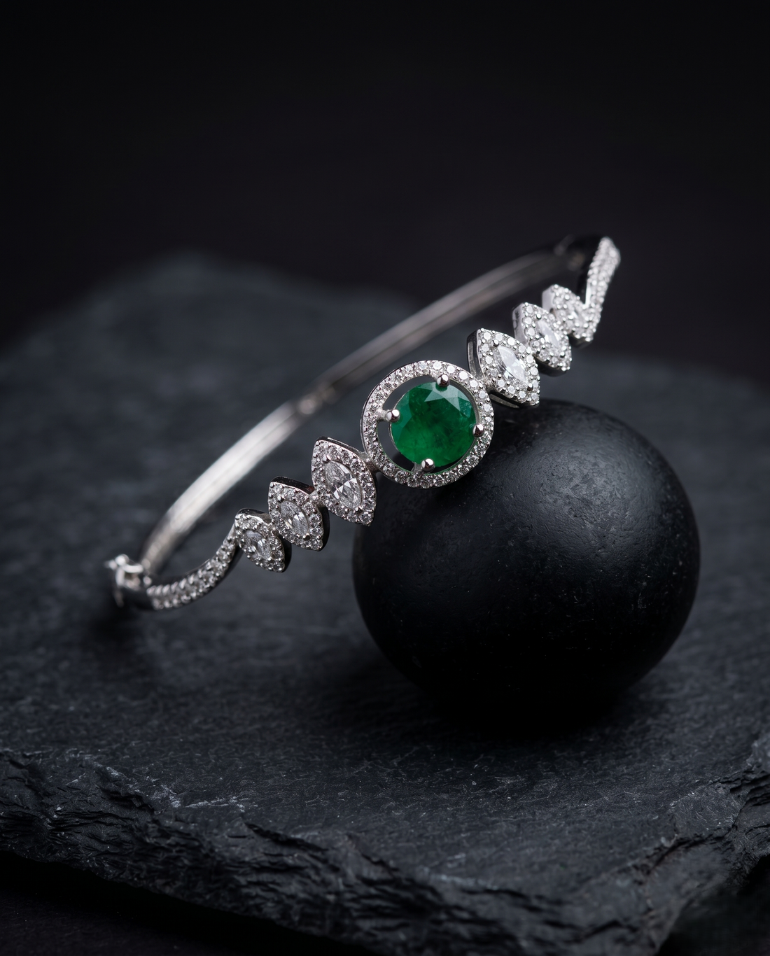 Luxury Diamond Bracelet with Green Stone | Openable Silver Finish Bracelet for Women with black background 
