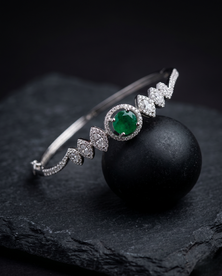 Luxury Diamond Bracelet with Green Stone | Openable Silver Finish Bracelet for Women with black background 
