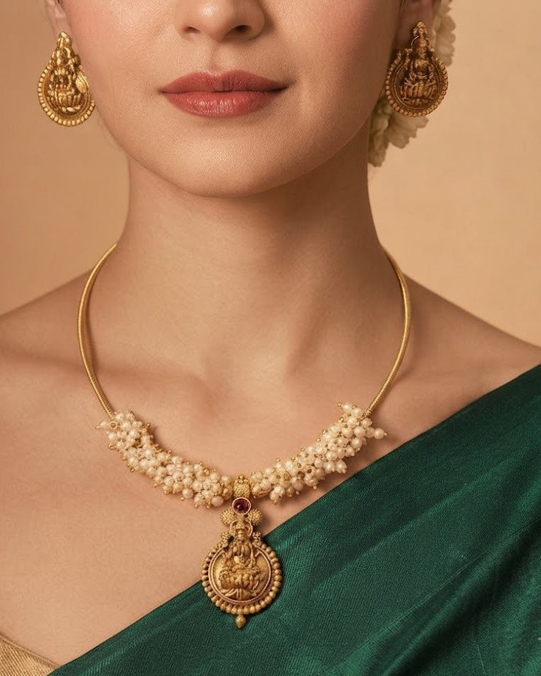 Mahalakshmi Pearl Grace Necklace Set. Featuring an elegant Goddess Lakshmi pendant, delicate pearl detailing, matching temple earrings,