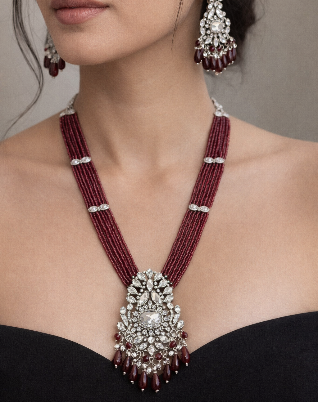 Maroon beaded necklace with silver pendant and matching earrings 