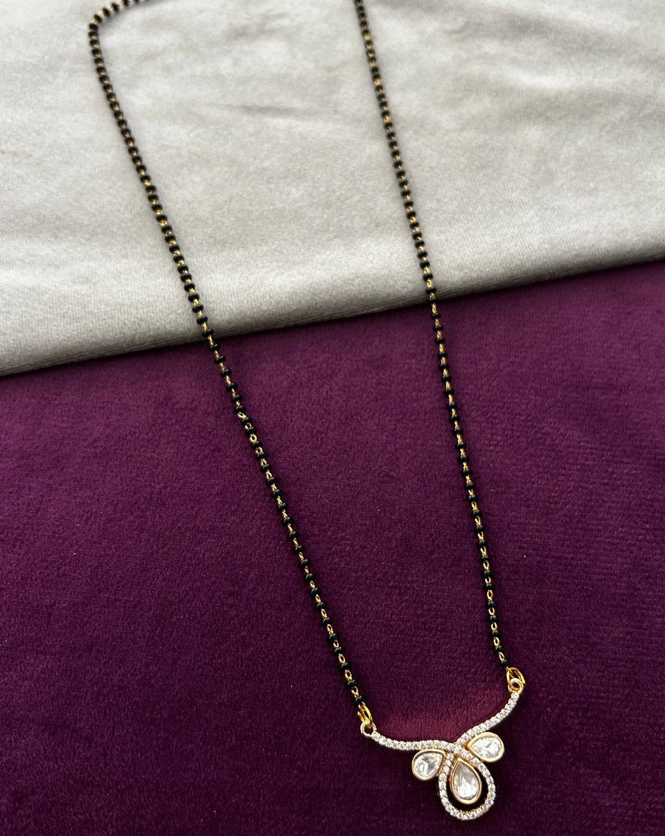 Necklace with a floral pendant on a purple and gray fabric background
