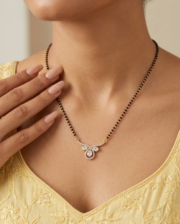 Necklace with a pendant worn by a person in a yellow top