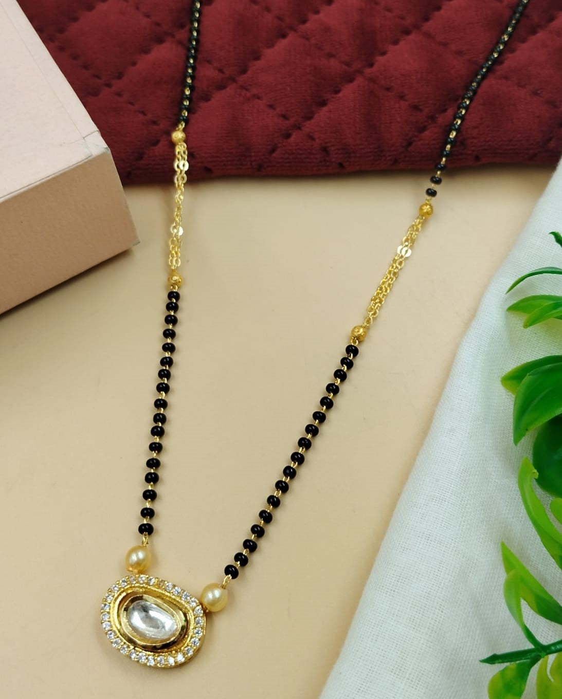 Elegant women’s mangalsutra designed with oval kundan styling and pearl accent